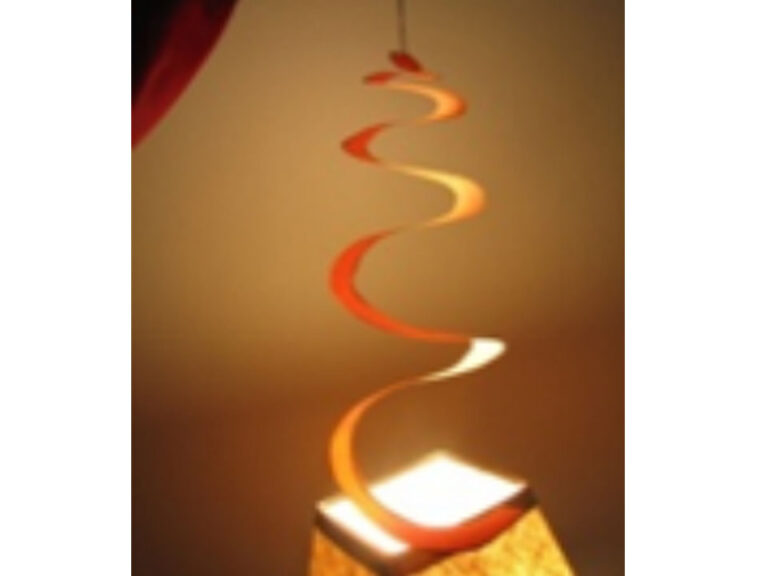 A photo of a paper spiral suspended over a square light.